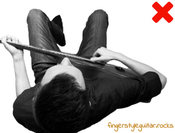 Body twisted while playing fingerstyle guitar