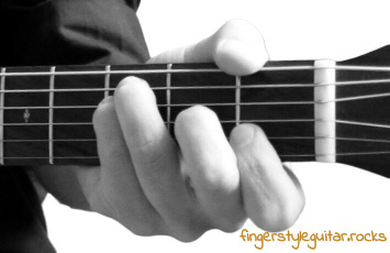 Thumb over neck while playing fingerstyle guitar