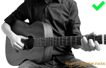 Rested right upper arm while playing fingerstyle guitar