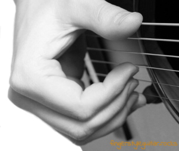 Picking the strings with the bare flesh of your fingers
