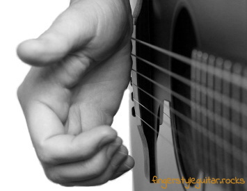 The side of the picking hand slightly touches the bass strings